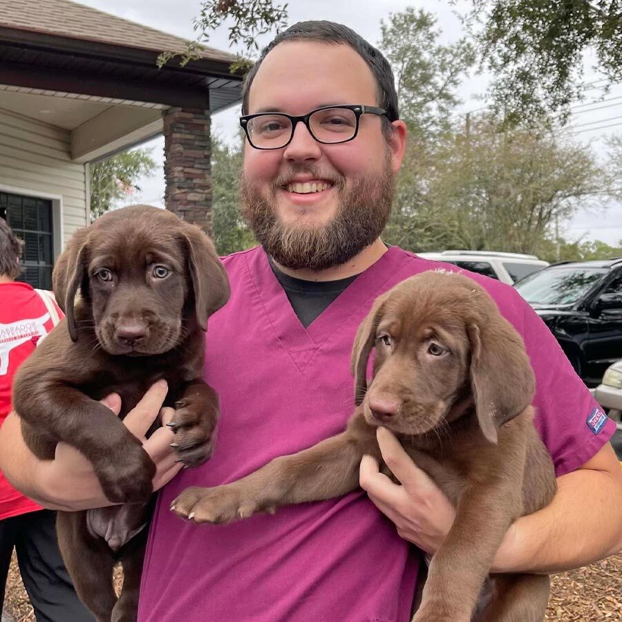 Staff Member Holding Puppies